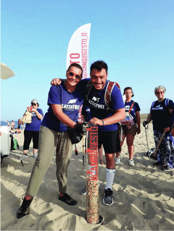 A group of plastic free volunteers showing the cigarettes collected on a beach